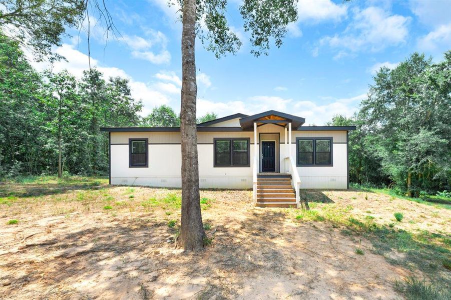Front exterior of a new home in , Gilmer, TX, highlighting curb appeal (Image 19). Front exterior of a new home in , Gilmer, TX, highlighting curb appeal (Image 19).