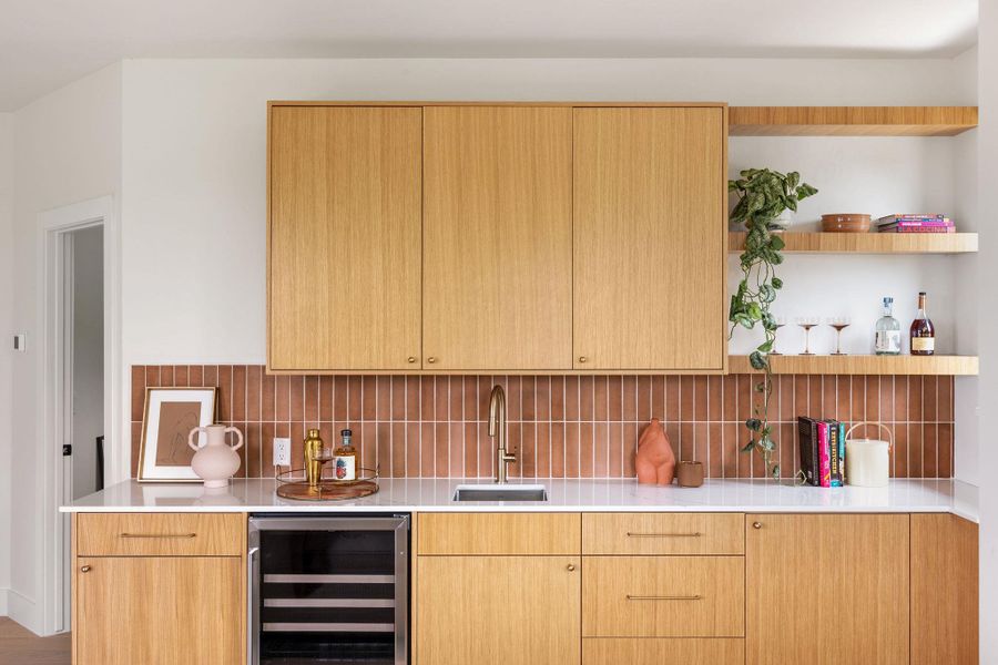 Indoor wet bar featuring beverage cooler and tasteful backsplash Indoor wet bar featuring beverage cooler and tasteful backsplash