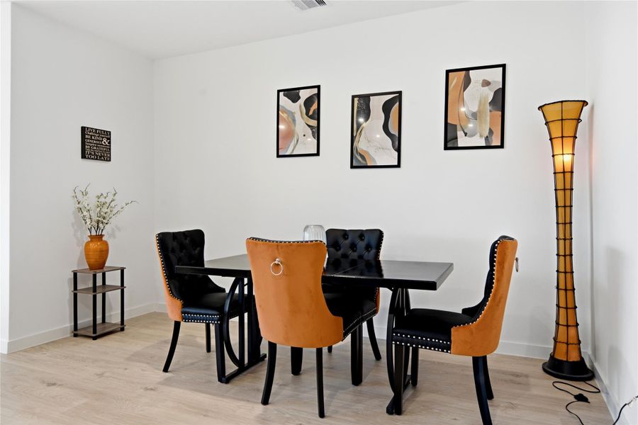 The dining area has its own designated space that could easily be repurposed to suite your needs.