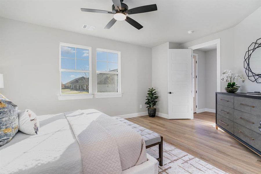 Bedroom featuring light wood-type flooring and ceiling fan