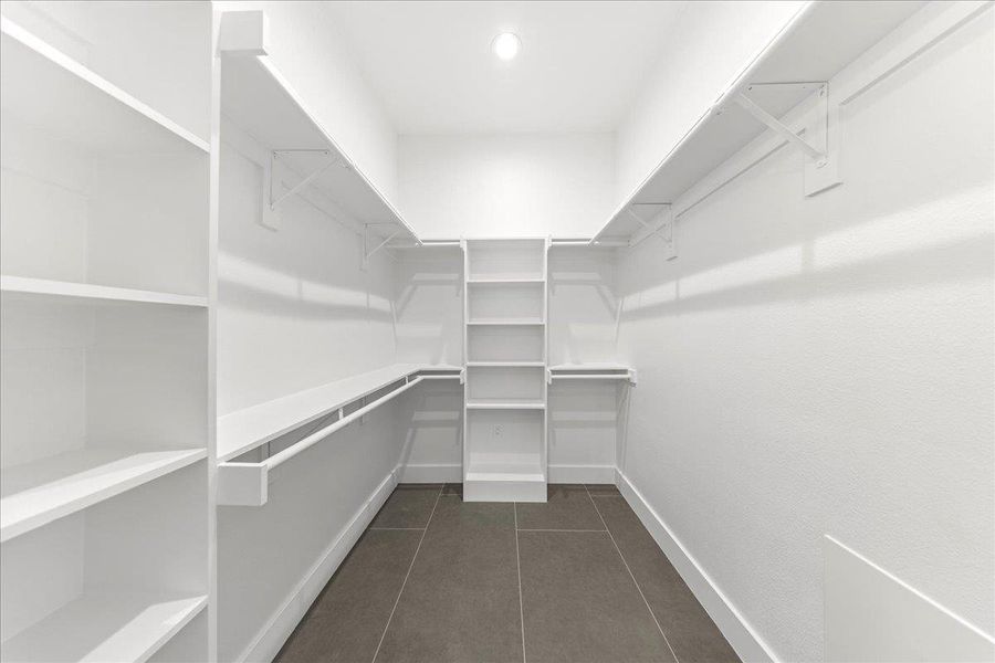 Spacious closet featuring dark tile patterned flooring Spacious closet featuring dark tile patterned flooring