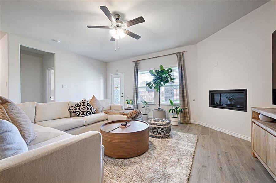 Living room featuring light hardwood / wood-style flooring and ceiling fan