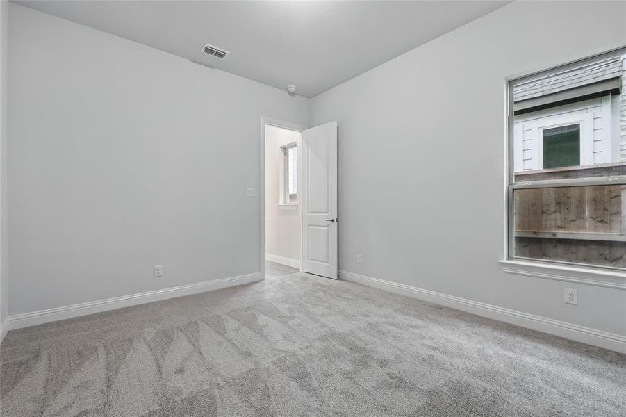 Unfurnished room with carpet floors and baseboards Unfurnished room with carpet floors and baseboards