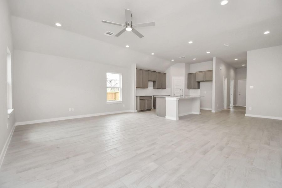 Gather the family and guests together in your lovely living room! Featuring soaring highceilings, recessed lighting, ceiling fan, custom paint, gorgeous floors, and large windows thatprovide plenty of natural lighting throughout the day. Sample photo of completed home with similar floor plan. Actual colors and selections may vary. Gather the family and guests together in your lovely living room! Featuring soaring highceilings, recessed lighting, ceiling fan, custom paint, gorgeous floors, and large windows thatprovide plenty of natural lighting throughout the day. Sample photo of completed home with similar floor plan. Actual colors and selections may vary.