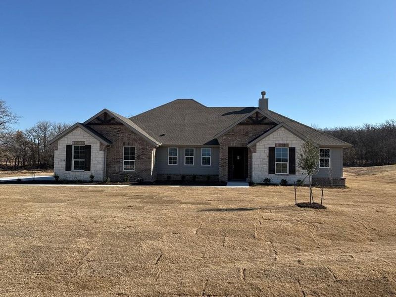 Craftsman-style house with a front yard and brick siding