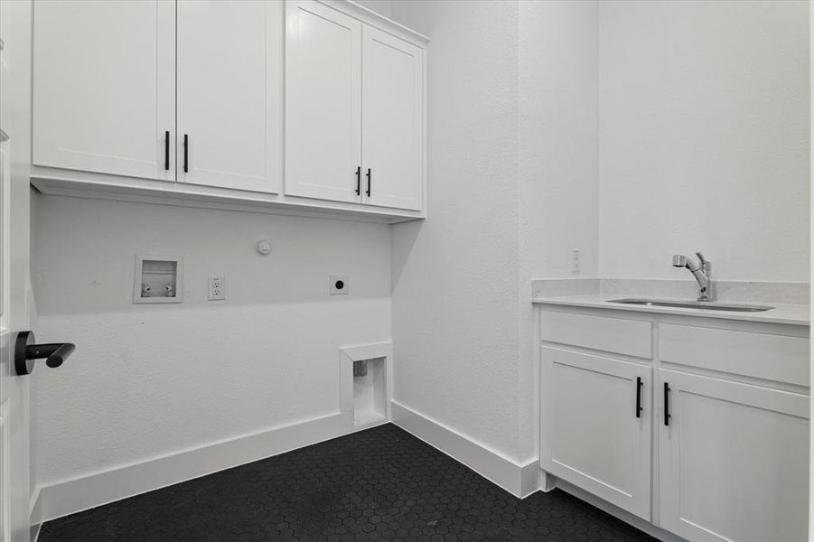 Laundry room featuring cabinet space, hookup for a washing machine, hookup for an electric dryer, and gas dryer hookup Laundry room featuring cabinet space, hookup for a washing machine, hookup for an electric dryer, and gas dryer hookup