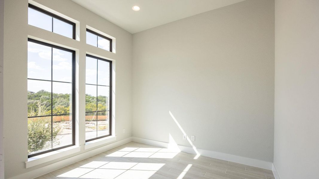 Spare room with wood finish floors and recessed lighting Spare room with wood finish floors and recessed lighting