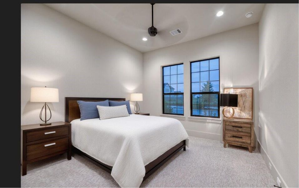 This spacious primary suite offers a peaceful retreat with relaxing views of the backyard.