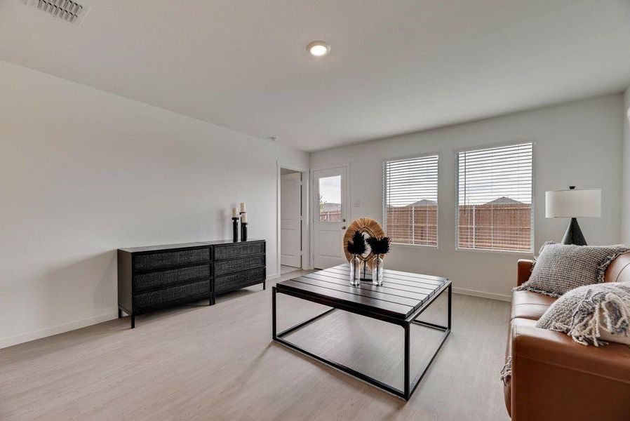 Living room featuring light wood-style floors and plenty of natural light