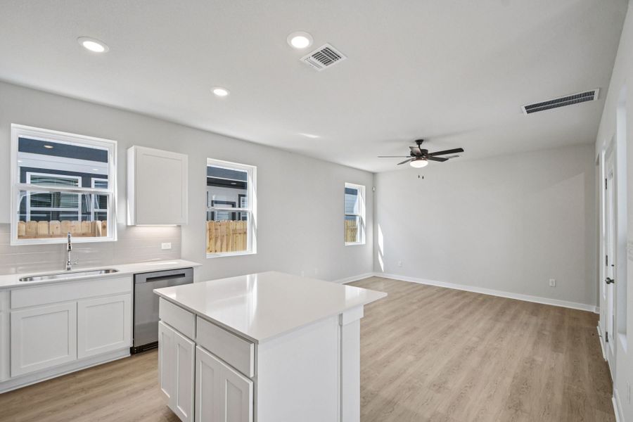 A kitchen with white cabinets.