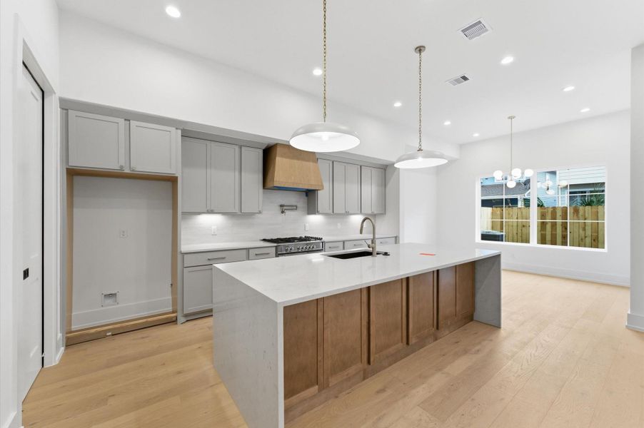 Gourmet style kitchen has a large island and ample cabinet space.