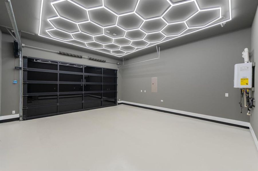 Garage with epoxy floors and geometric lighting. Garage with epoxy floors and geometric lighting.