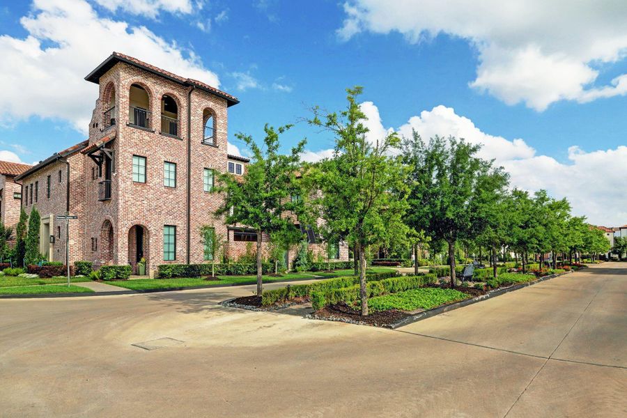 A stately, tree-lined boulevard unfolds beyond the gates, creating a serene and welcoming arrival.