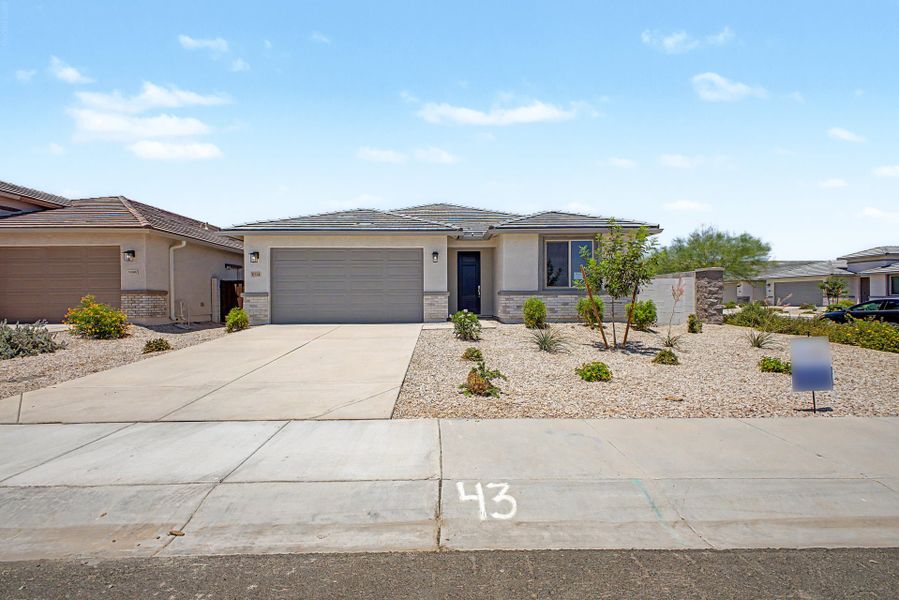 Front exterior of a new home in Wildera, San Tan Valley, AZ, highlighting curb appeal (Image 2). Front exterior of a new home in Wildera, San Tan Valley, AZ, highlighting curb appeal (Image 2).