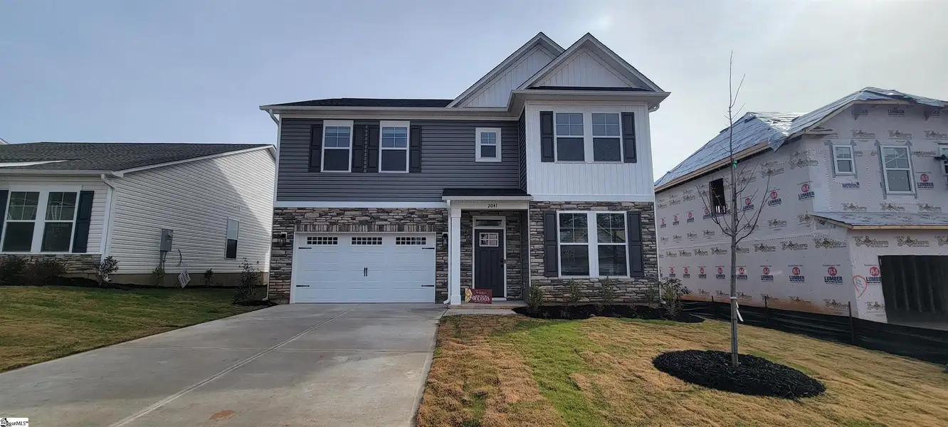 Front exterior of a new home in Halton Oaks, Spartanburg, SC, highlighting curb appeal (Image 1).