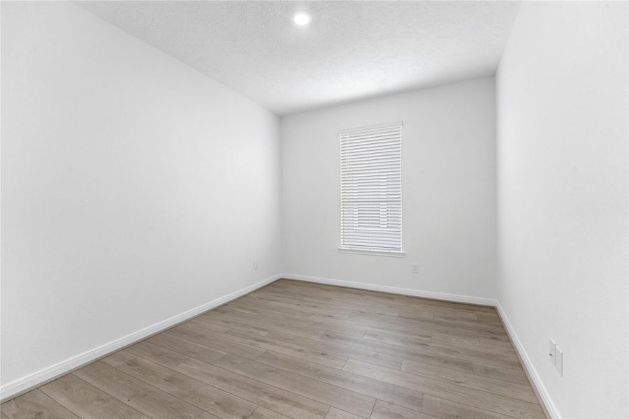 The Den is a versatile and additional living space that can be used as a home office, hobby or play room. It features Layton Lake vinyl plank flooring in Soft Beige, high ceilings, large window with privacy blinds and neutral paint.