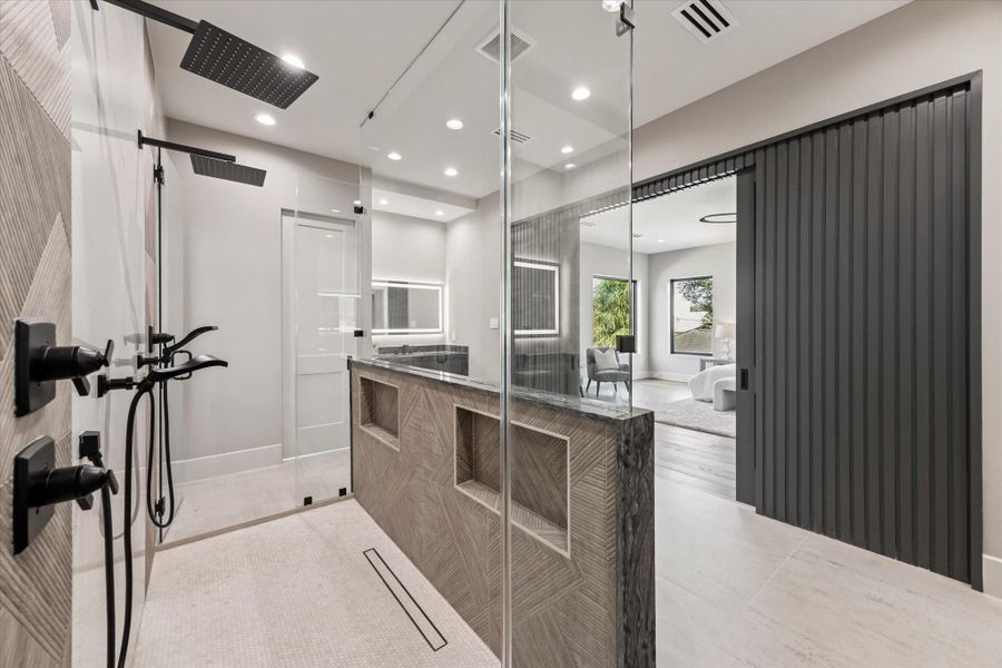 Sleek fixtures and textured wall accents enhance the sophisticated ambiance, making this bathroom a true retreat.