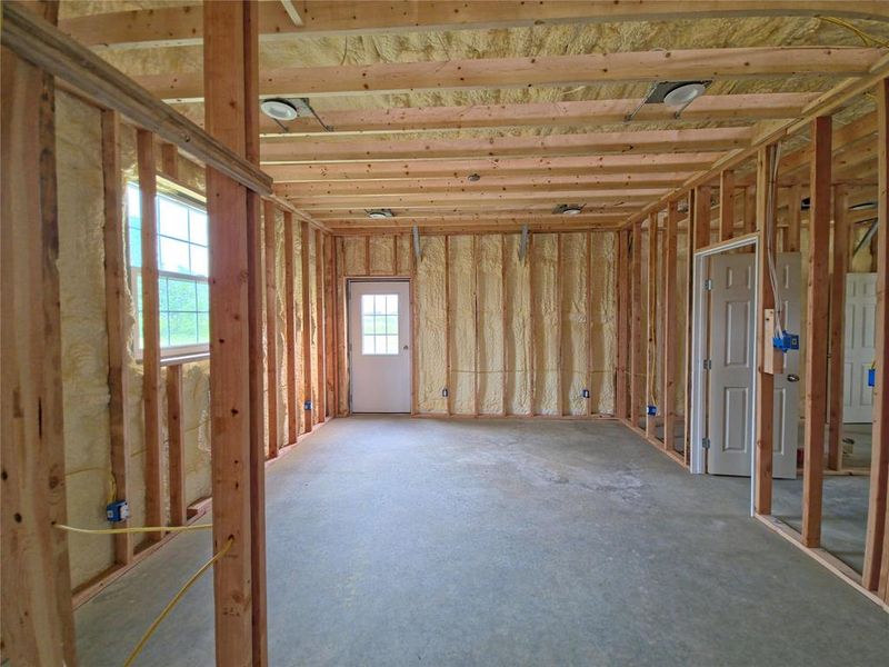 A bedroom with natural light and access to the yard