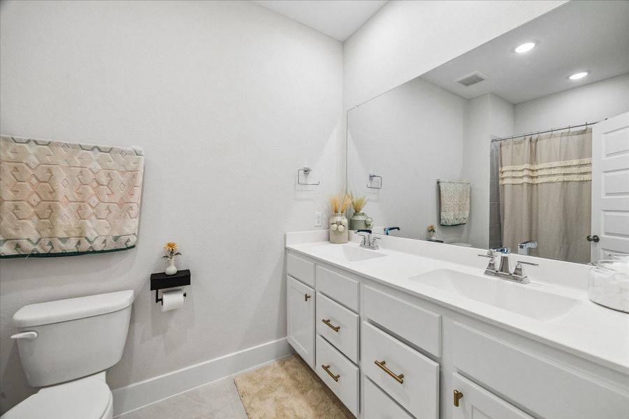 Located just off the entry, this bright and versatile room is currently used as a home gym but could easily serve as a private office, guest bedroom, or flex space to fit your needs.