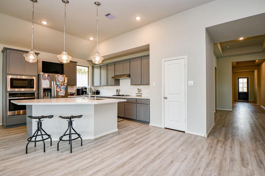 Open kitchen with large island and single basin farmhouse SS sink Open kitchen with large island and single basin farmhouse SS sink