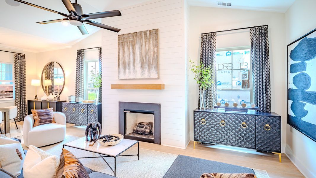 Gathering room with fireplace, ceiling fan, large windows