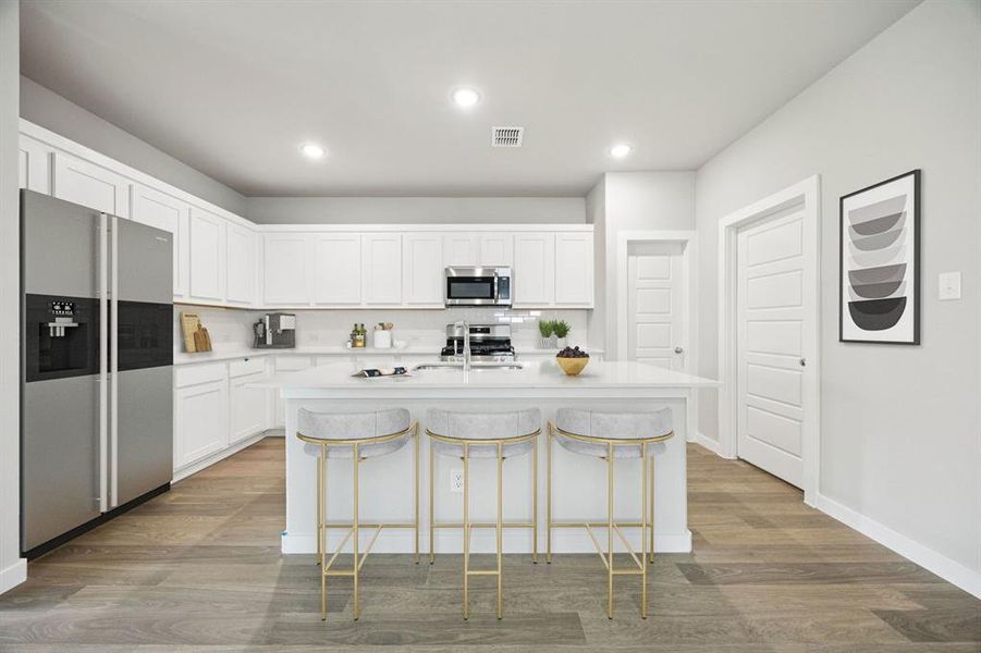 Kitchen in the Hayden home plan by Trophy Signature Homes – REPRESENTATIVE PHOTO