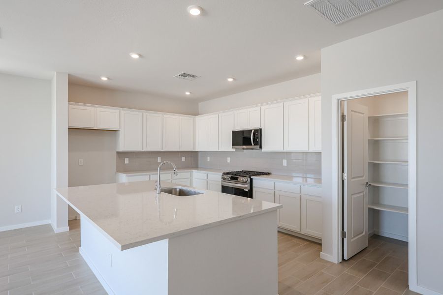 A kitchen with white cabinets. A kitchen with white cabinets.