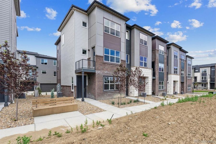Front exterior of a new home in Attainable Townhomes at Grand Vue at Interlocken, Broomfield, CO, highlighting curb appeal (Image 15).