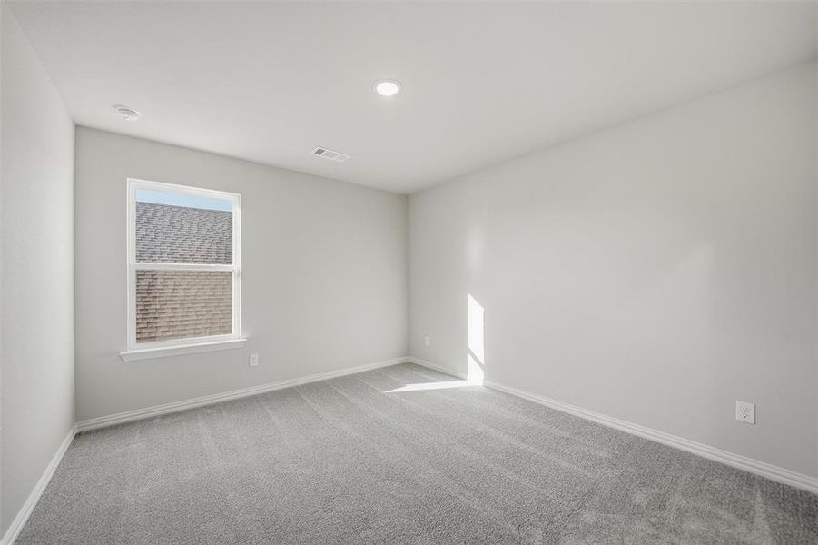 Empty room featuring light colored carpet and recessed lighting Empty room featuring light colored carpet and recessed lighting