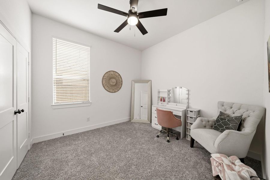 The fourth bedroom offers plush carpet and a window with blinds which fills the space with soft natural light for a bright, refined feel.