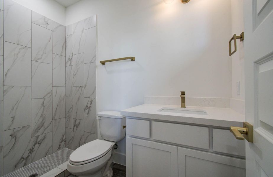 Crisp and modern, 1st floor bathroom (glass shower enclosure to be installed). Choose your mirror and hardware to put your own personal touch, or receive a builder credit. Builder will install.