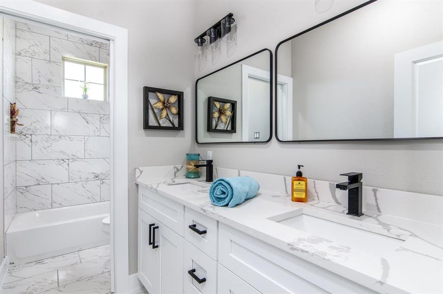 Secondary bath with double vanities, and calacatta quartz, located between 2nd and 3rd bedrooms.