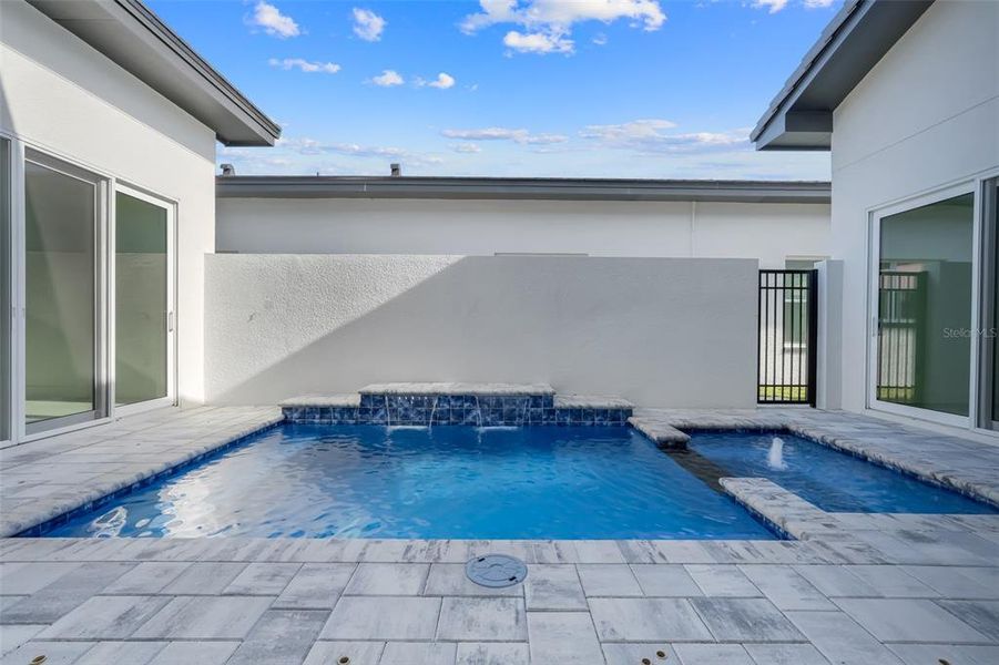 Exterior details and patio area of a home in Hampton Green at Providence, Davenport (Image 4).