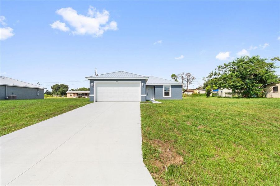 Front exterior of a new home in , Frostproof, FL, highlighting curb appeal (Image 1).