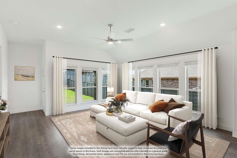 Living room with vaulted ceiling, ceiling fan, large windows, white sectional sofa, and dark hardwood floors Living room with vaulted ceiling, ceiling fan, large windows, white sectional sofa, and dark hardwood floors