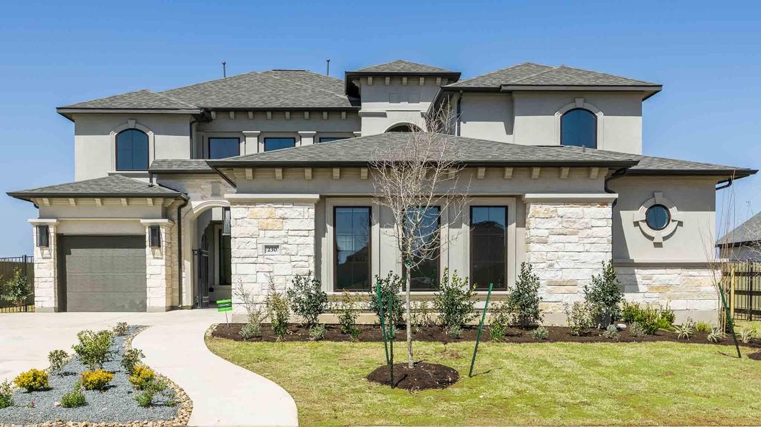 Prairie-style house featuring stone siding, driveway, a garage, and a front lawn Prairie-style house featuring stone siding, driveway, a garage, and a front lawn