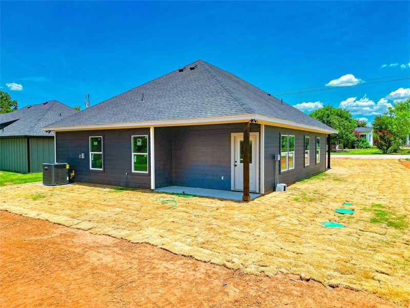 Rear view of house with cooling unit and a patio