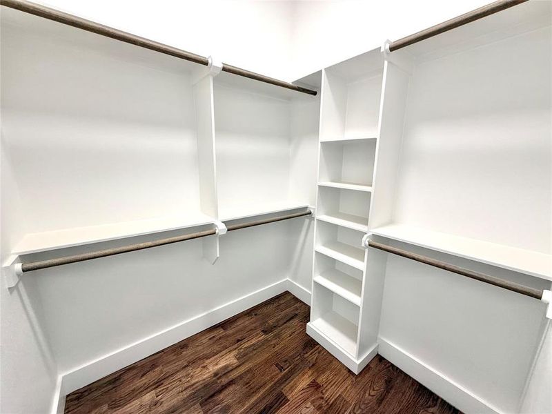 Spacious closet with dark wood finished floors Spacious closet with dark wood finished floors