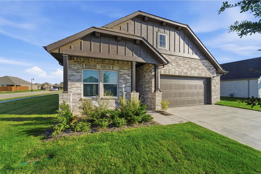 Front exterior of a new home in Saddlebrook Estates, Waxahachie, TX, highlighting curb appeal (Image 2). Front exterior of a new home in Saddlebrook Estates, Waxahachie, TX, highlighting curb appeal (Image 2).