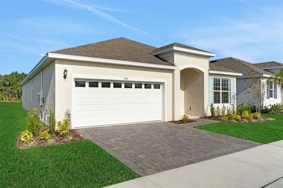 Front exterior of a new home in Reserve at Hammock Oaks, Lady Lake, FL, highlighting curb appeal (Image 2). Front exterior of a new home in Reserve at Hammock Oaks, Lady Lake, FL, highlighting curb appeal (Image 2).