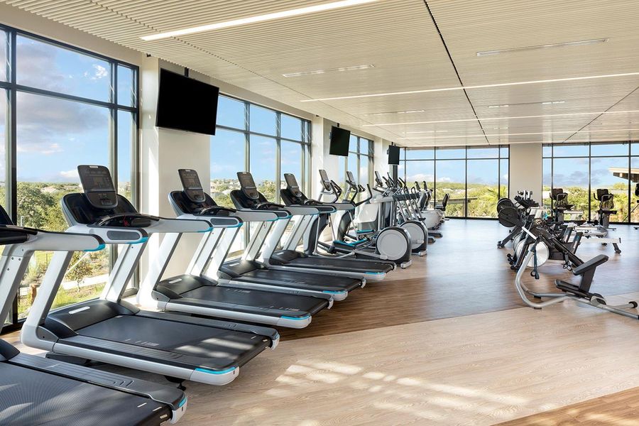 Exercise room featuring floor to ceiling windows and wood finished floors