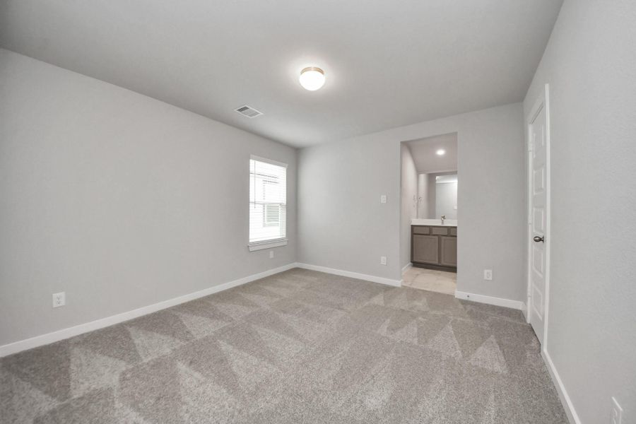 Secondary bedroom features plush carpet, custom paint, large window with privacy blindsand access to the Jack and Jill bath.