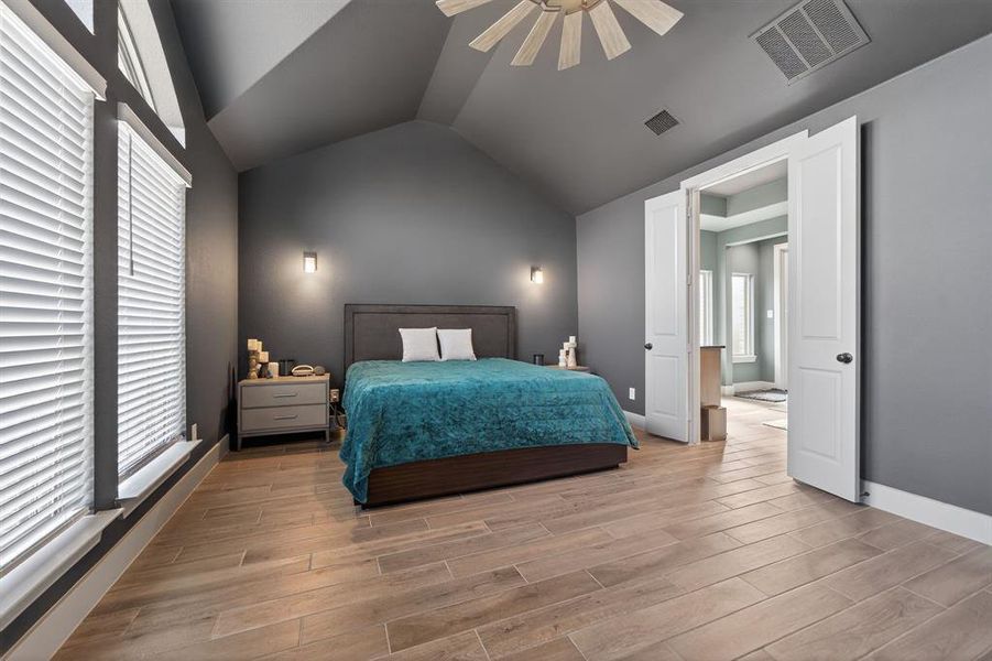 Private primary retreat with soaring ceilings and tile flooring Private primary retreat with soaring ceilings and tile flooring