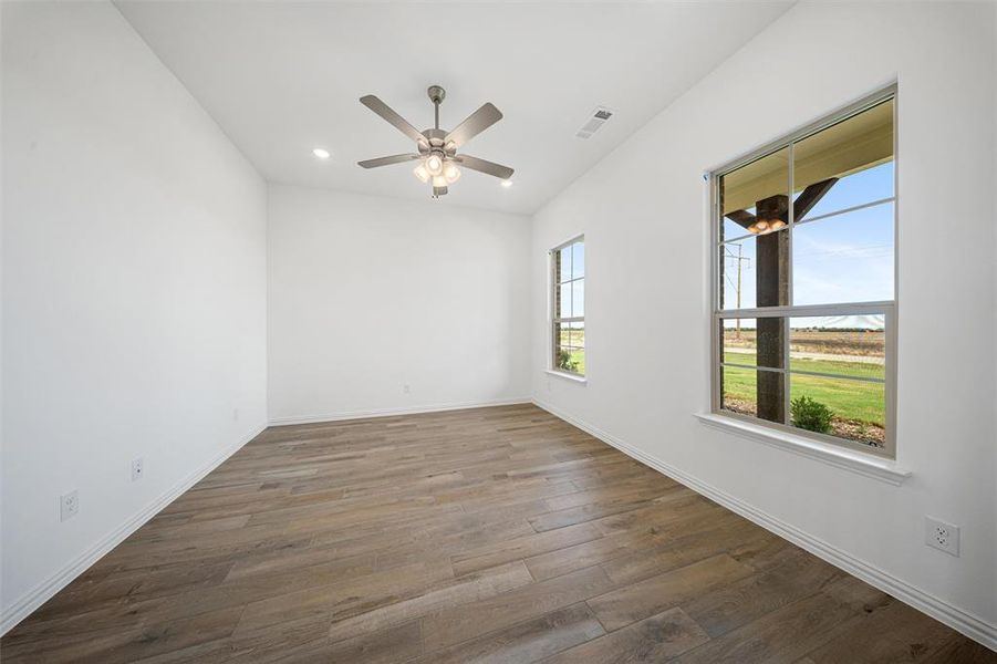 Unfurnished room with dark wood-style floors, recessed lighting, and a ceiling fan Unfurnished room with dark wood-style floors, recessed lighting, and a ceiling fan