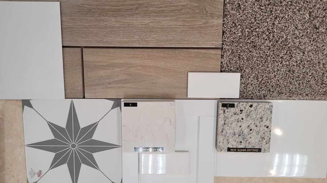 Material samples including wood flooring, carpet, tile, and countertop options in neutral tones Material samples including wood flooring, carpet, tile, and countertop options in neutral tones
