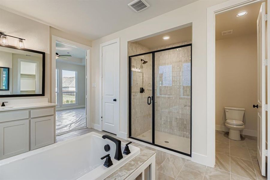 Full bathroom with a garden tub, a stall shower, vanity, a ceiling fan, and light tile patterned flooring
