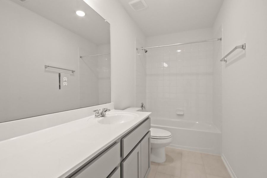 The secondary bath features tile flooring, white cabinetry and light countertops and a shower/tub combo. Perfect for accommodating any visiting family and friends. The secondary bath features tile flooring, white cabinetry and light countertops and a shower/tub combo. Perfect for accommodating any visiting family and friends.