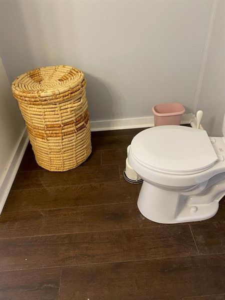 Bathroom featuring hardwood / wood-style floors and toilet Bathroom featuring hardwood / wood-style floors and toilet