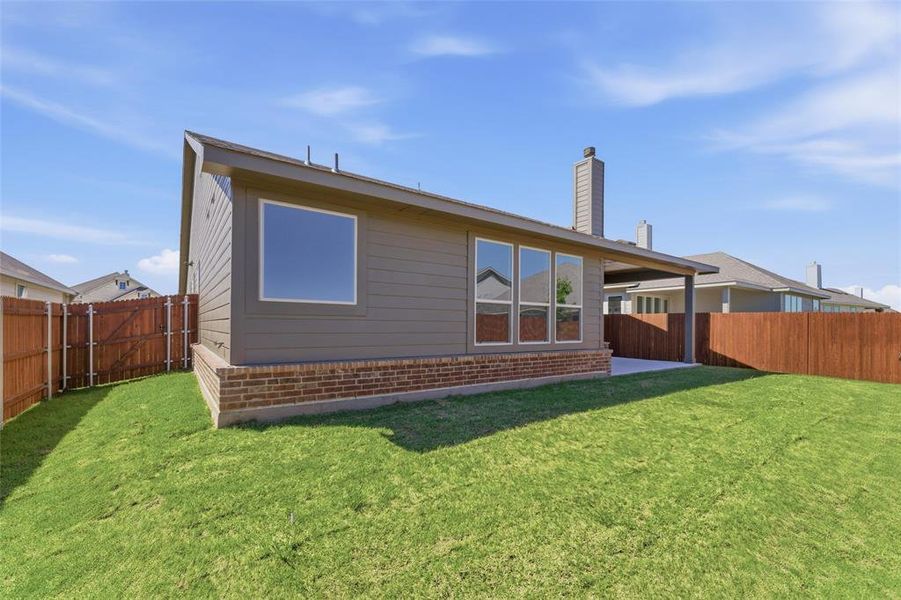 Back of house with a patio, a fenced backyard, a chimney, and brick siding