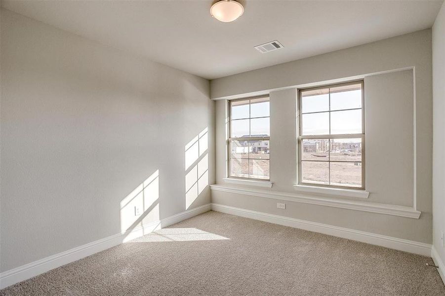 Empty room with light colored carpet